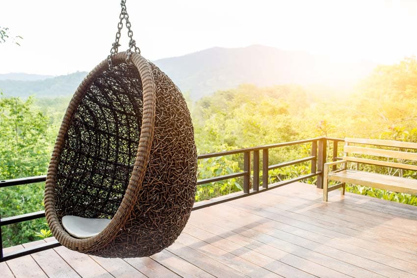 Outdoor deck with wood flooring, and hanging egg chair