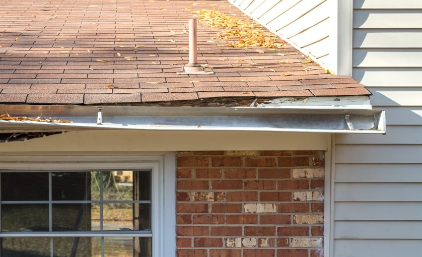 Rotting facia board and gutters are falling away from the house roof