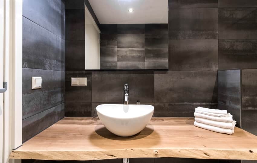 Small curved vessel sink on a live edge countertop in bathroom