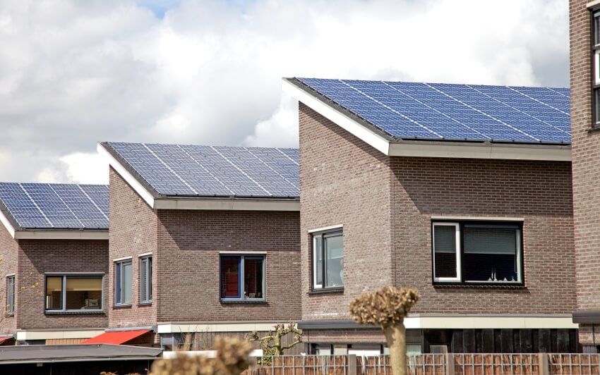 Solar panels on brick houses roofs in neighborhood