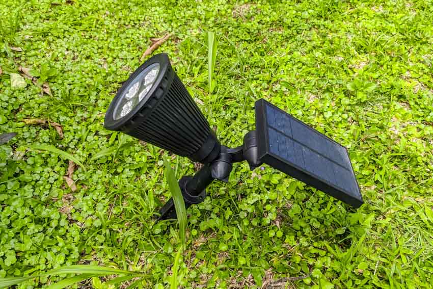 Solar powered flood light in a grassy area