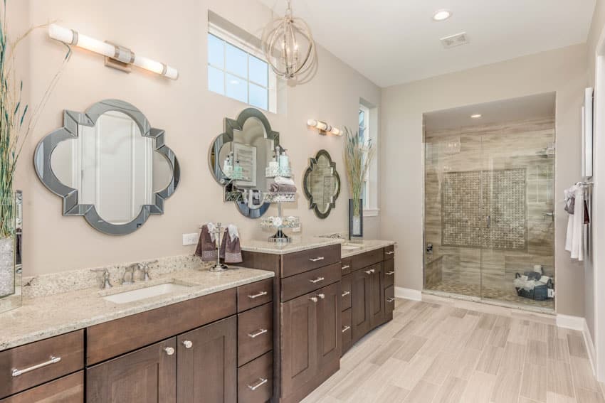 Bathroom with wood cabinets, three mirrors and shower area