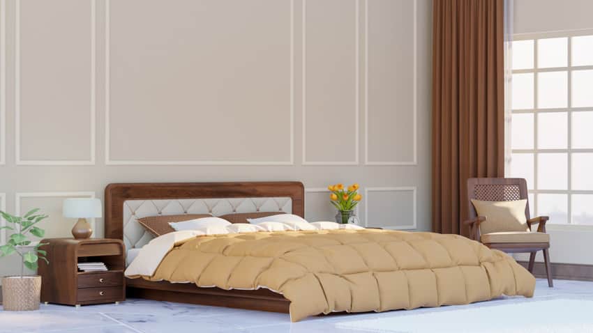 Spacious bedroom with comforter, headboard, nightstand, chair, and window curtain