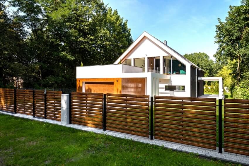Spacious white house with wooden decoration on garage and Ipe wood fence