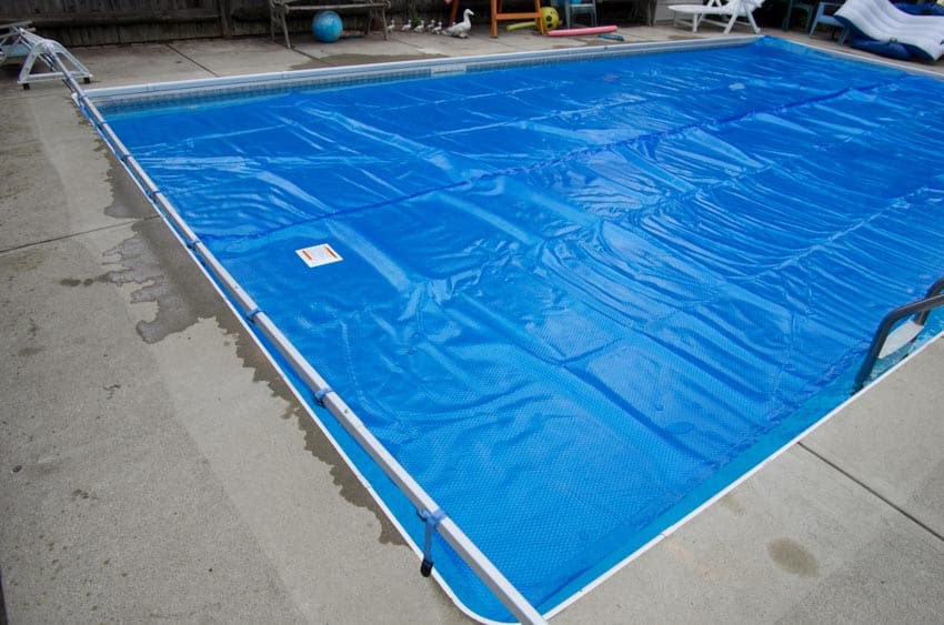 Swimming pool with a cover on top of it