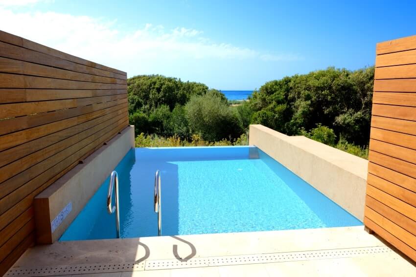 Swimming pool with wood fence in a sea view villa