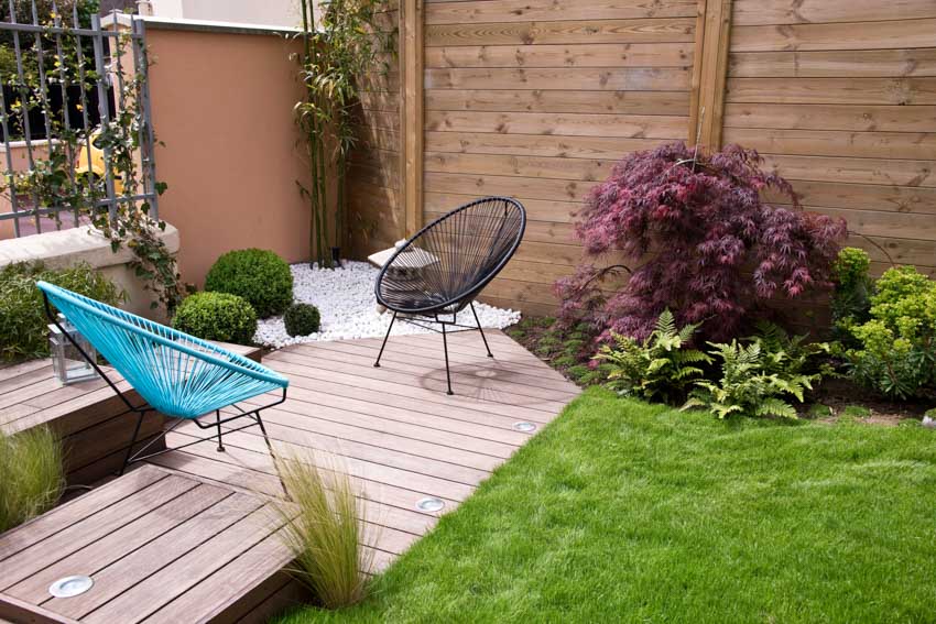 Terrace garden with wood deck, chairs, wood fence, and plants