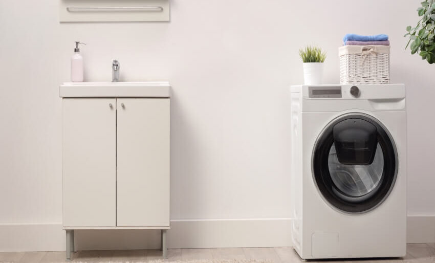 Freestanding washer with sink nearby