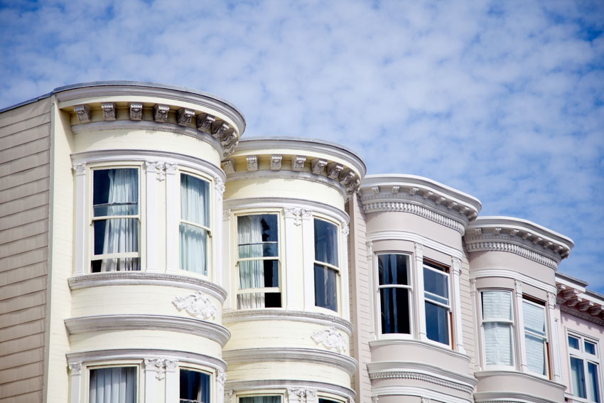 Victorian-style apartment buildings with white bay windows