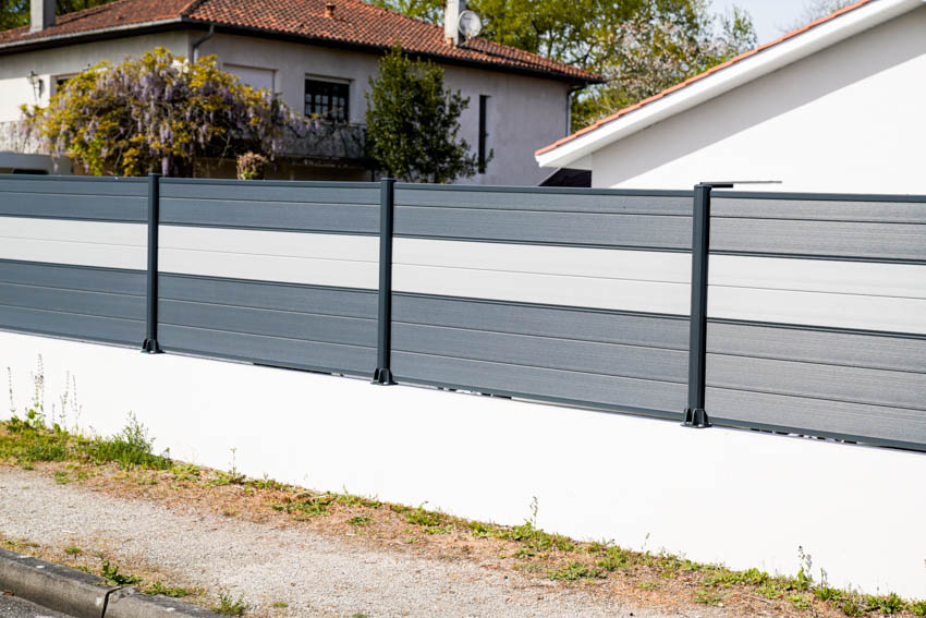 White and gray Hardie board fence composed of horizontal planks