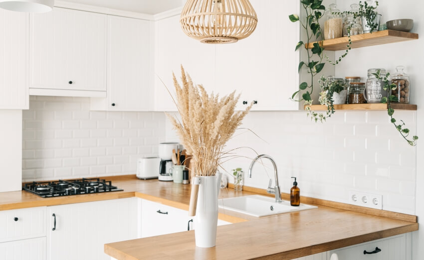 White U-shaped kitchen with open shelves, subway tile backsplash, and wood grain counters