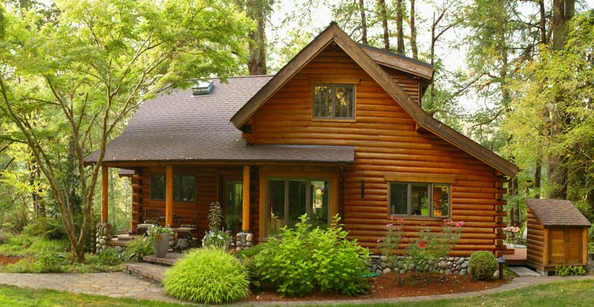 Wood cabin exterior with log siding, windows, and roof