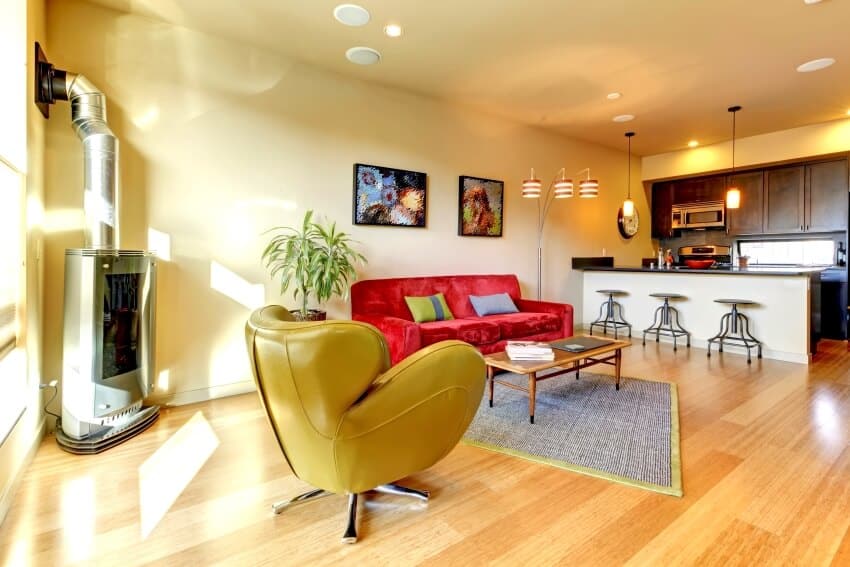 Yellow large modern living room with red velvet sofa, floor lamp, and wire brushed wood floors