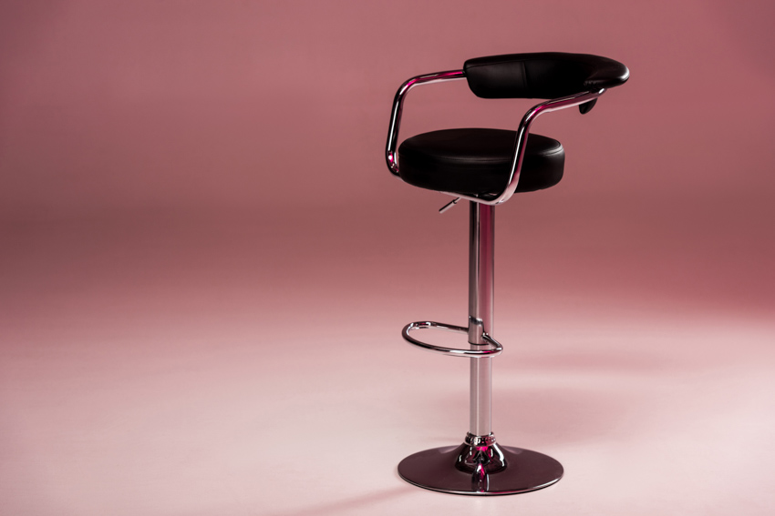 A high leather bar stool with arm rest, and cushioning