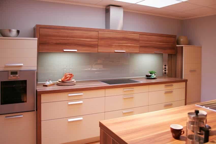 A modern and new kitchen with wood tile countertops and cabinets