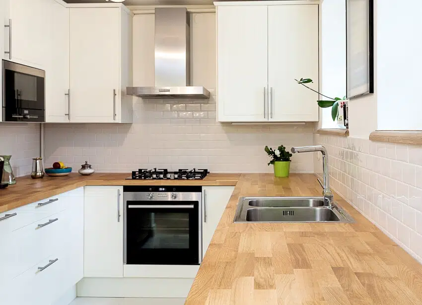 A modern wooden countertop in a white kitchen 