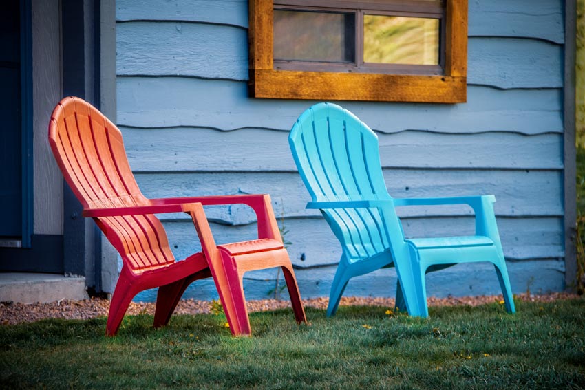Backyard area with blue and red Muskoka chairs