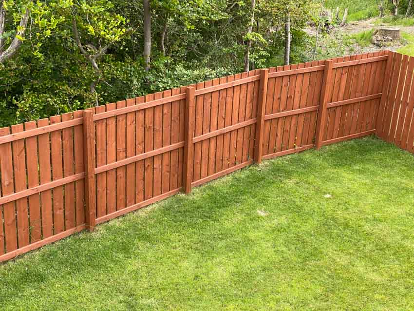 Backyard area with redwood board fences