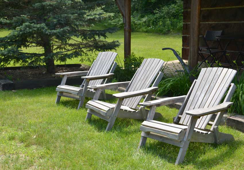 Backyard area with three gray Muskoka chairs