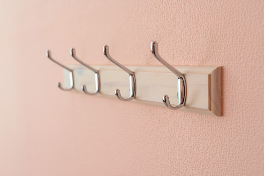 Bathroom wall with mounted hooks for towels and clothes