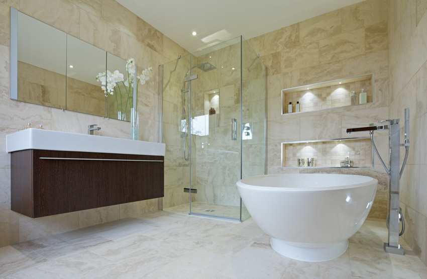 Bathroom with limestone shower, flooring ,tub glass, door, floating vanity, and mirror