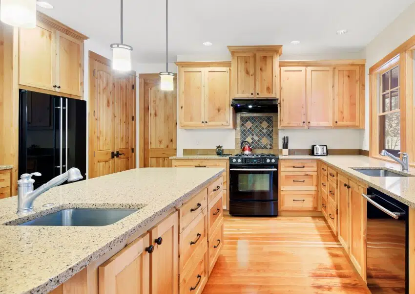 Beautiful kitchen with alder wood cabinets, granite counter tops, and black appliances
