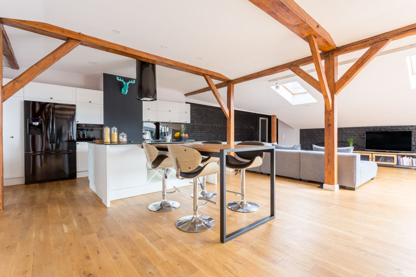 Beautiful kitchen with stools, and exposed ceiling beams