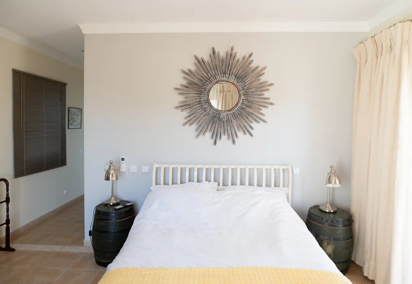 Bedroom with DIY nightstands, wall decor, wood floor, and window curtain