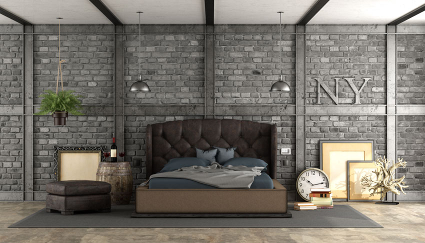 Bedroom with barrel nightstand, leather headboard, ottoman, pillows, and different decor pieces