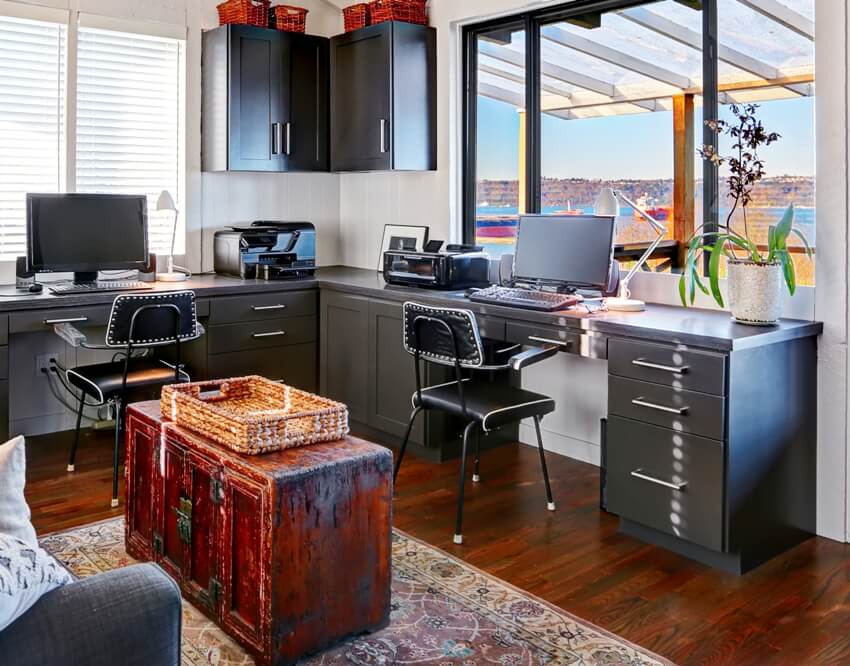 A bright beautiful home office interior design with pedestal filing cabinets and other office supplies and equipment