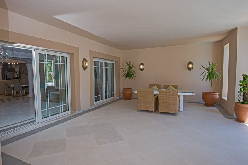 Covered porch with mounted lights and table set