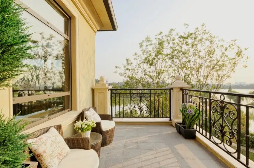 Decorations and furniture in modern balcony with cast iron railings