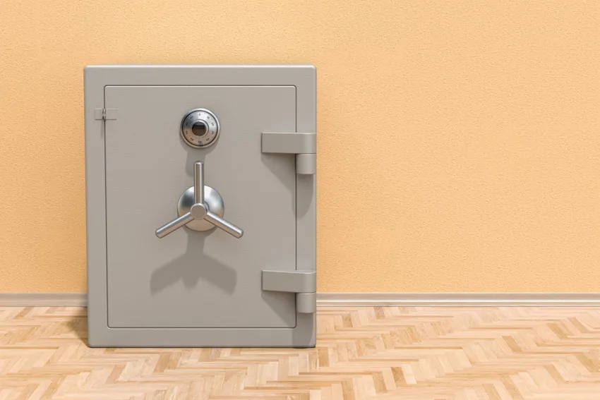 Empty room interior with freestanding safe and wood flooring