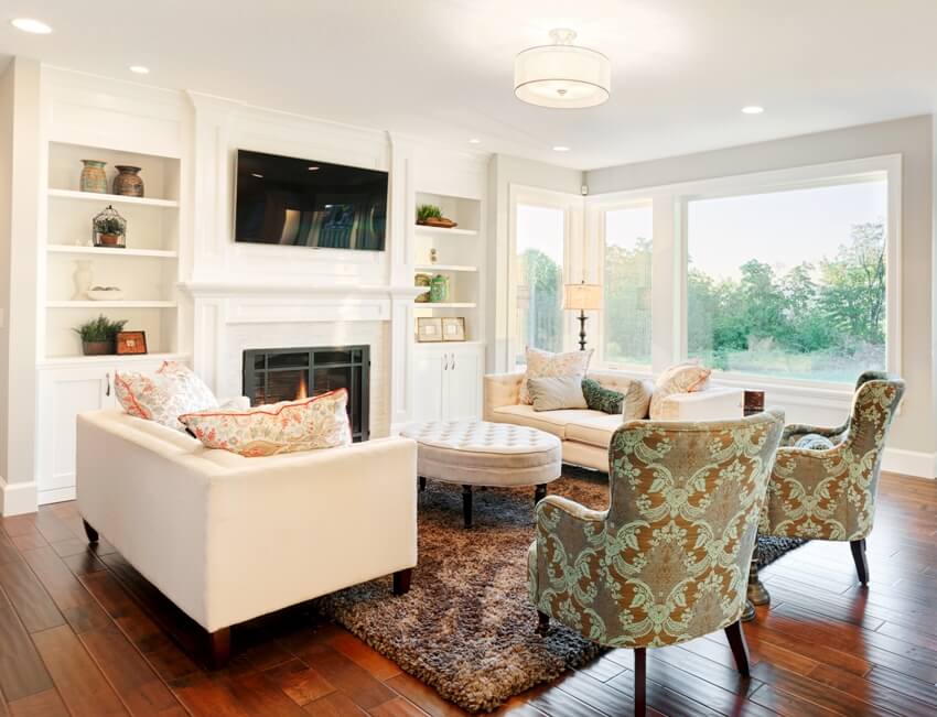 A furnished living room with flushed overhead lighting in a luxury home