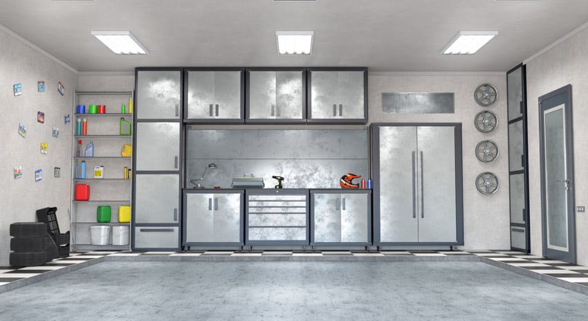 Garage workbench with stainless steel sheet backsplash, cabinets, and concrete flooring