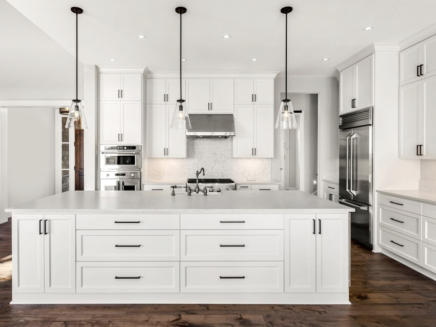 Gorgeous kitchen with island, pendant lights and white shaker cabinets