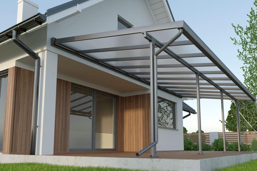House exterior with patio, canopy roofing, wood slat wall, and glass door