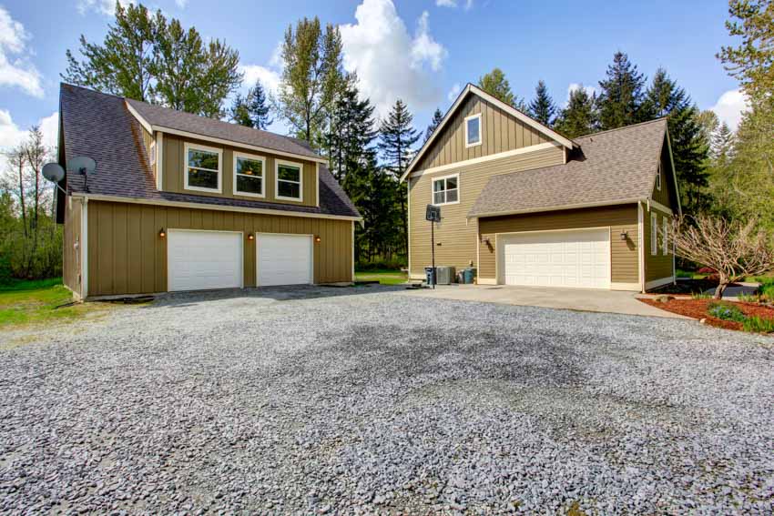 House with pitched roof, recycled concrete driveway, large garage, and dormer