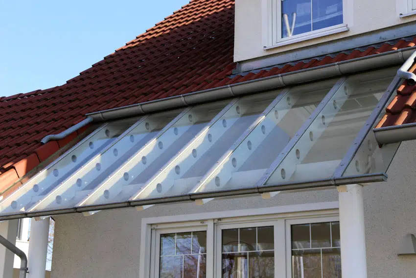 Red shingle roof and glass canopy 