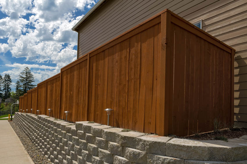 House exterior with redwood fence, and wood siding wall