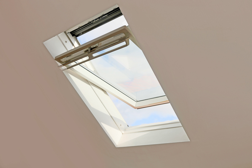 House interior ceiling with egress skylight window, and white painted wall