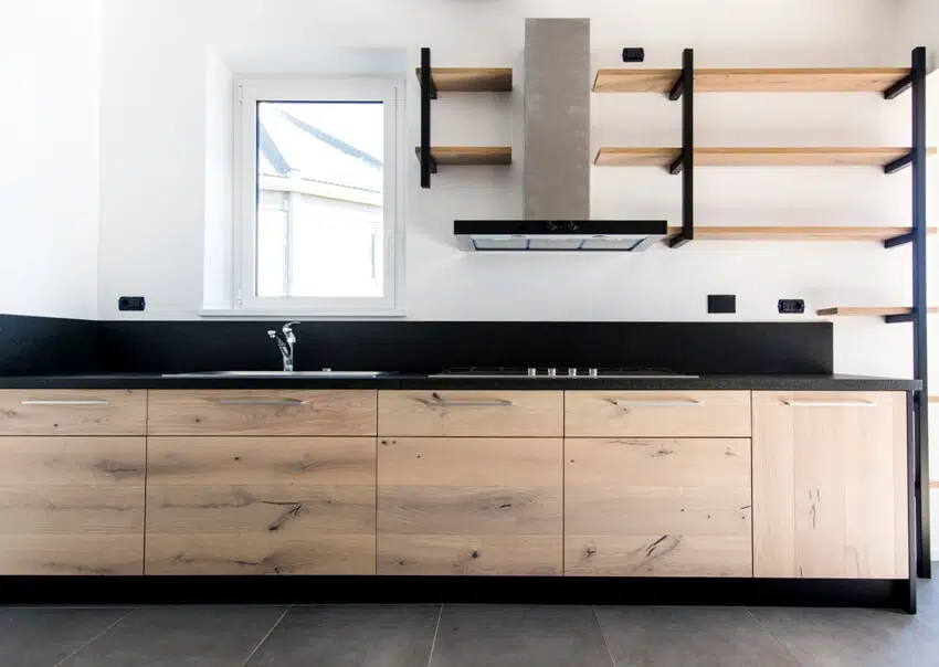 Kitchen interior industrial design with exposed shelves, alder cabinets, and dark gray floor 