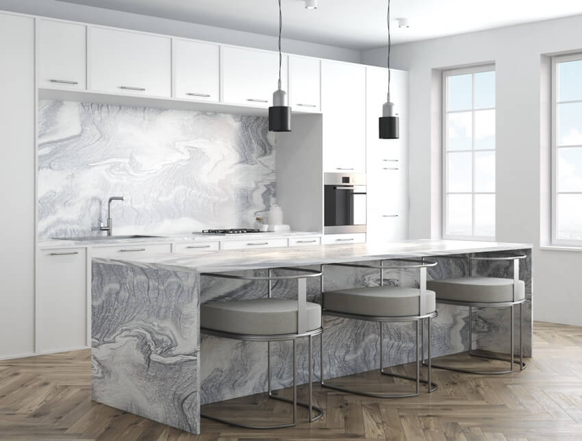 Kitchen with herrinbone pattern wood flooring and marble waterfall countertop