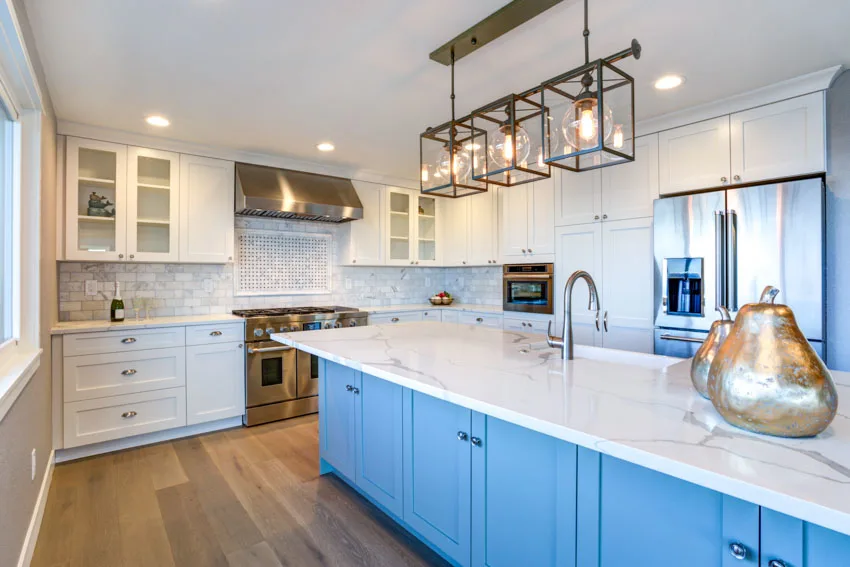Kitchen with Carrara marble backsplash, countertop, pendant lights, wood floors, cabinets, and range hood