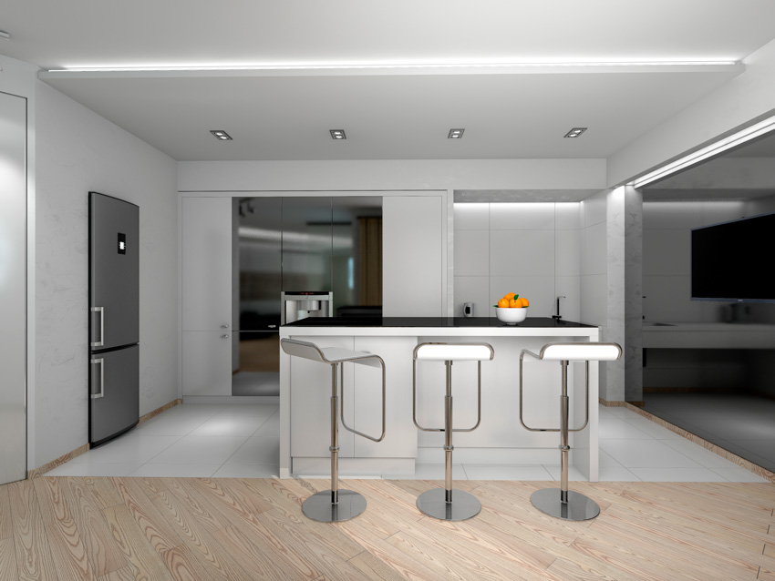 Kitchen with center island, low back bar stools, ceiling lights, white walls, and refrigerator