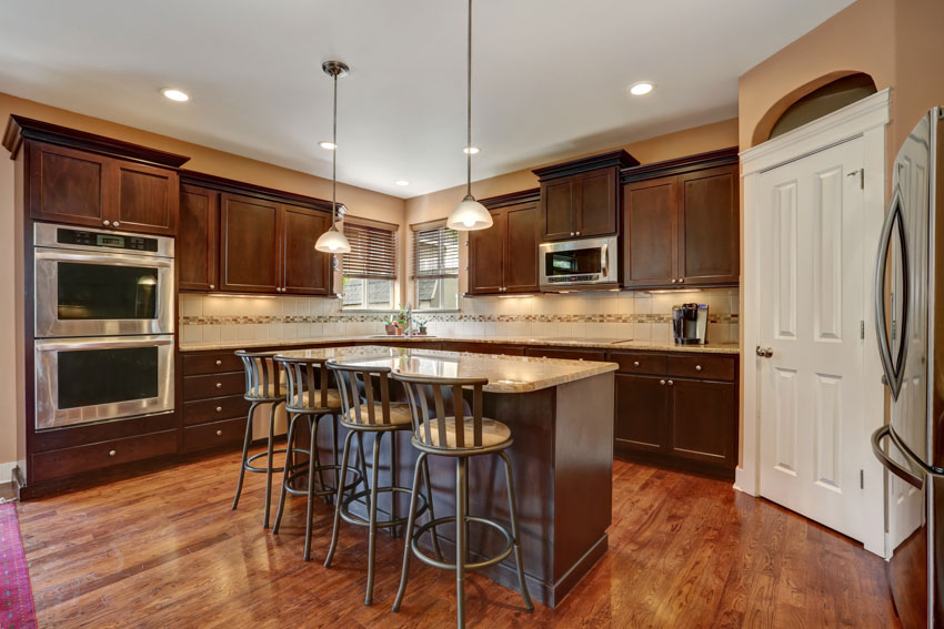 Kitchen with distressed metal brushed stools