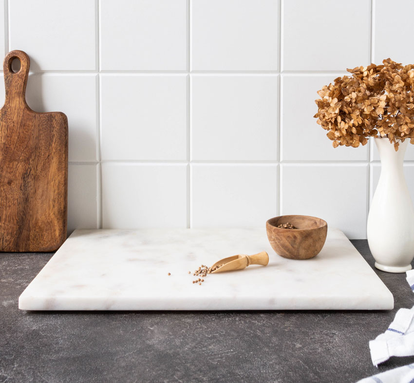 Kitchen with countertop, marble cutting board, and vase