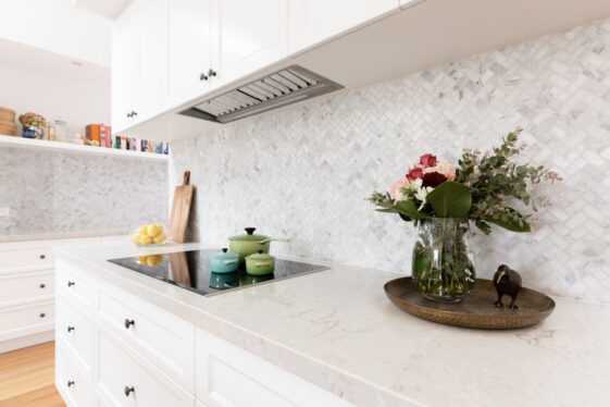 Carrara Marble Backsplash Types Pros And Cons   Kitchen With Herringbone Carrara Marble Backsplash Countertop Induction Stove And Cabinets Is 561x374 