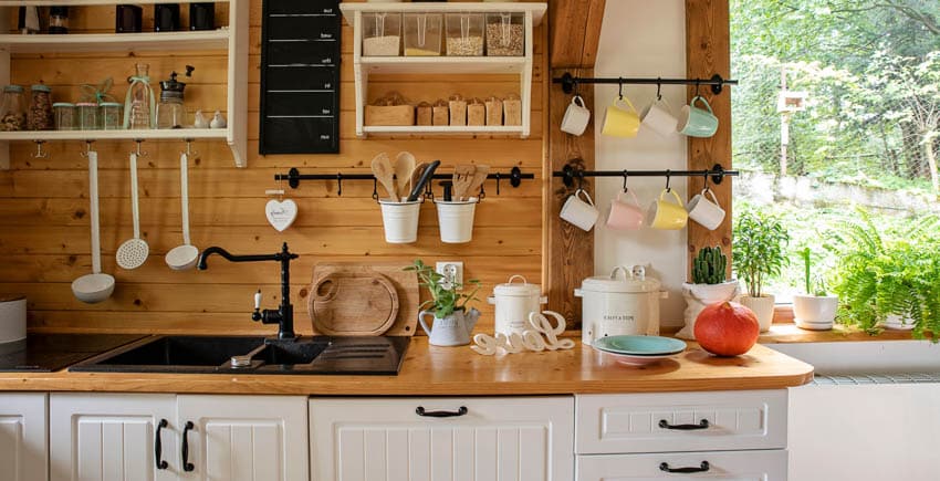 Kitchen with DIY shiplap backsplash, wooden countertops, shelves, drawers, and window