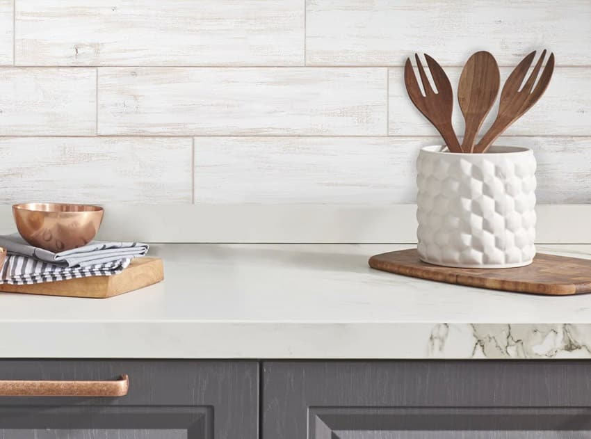 Kitchen with shiplap peel and stick backsplash, countertop, and kitchenware